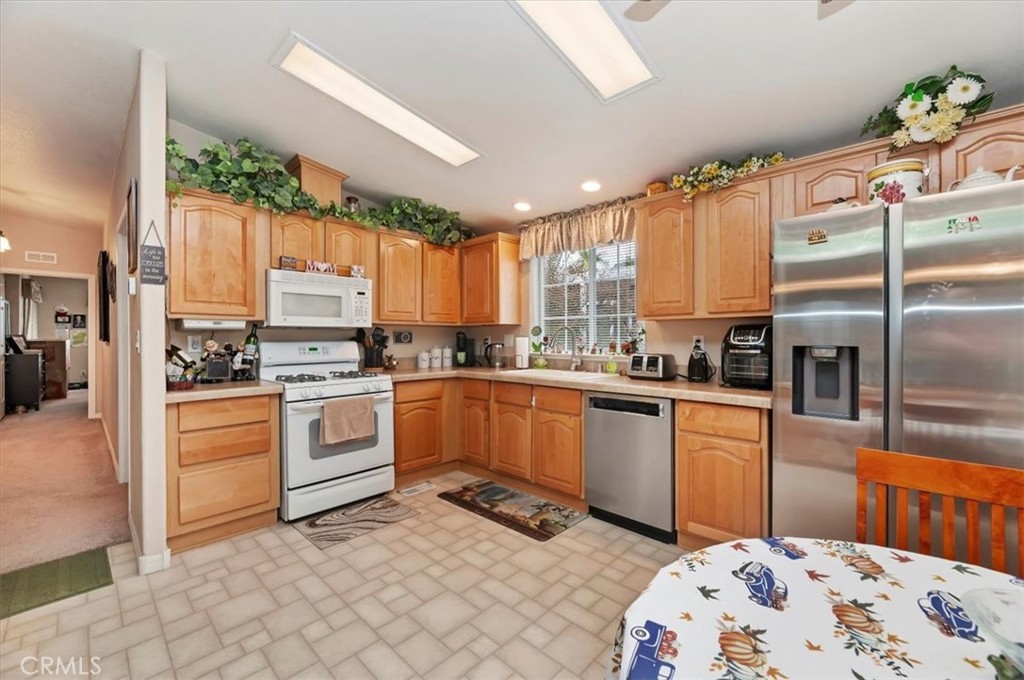 31130 South General Kearny Road, Unit 147 Temecula, CA 92591 - Photo 10 of 42 a kitchen with granite countertop a sink stainless steel appliances and white cabinets