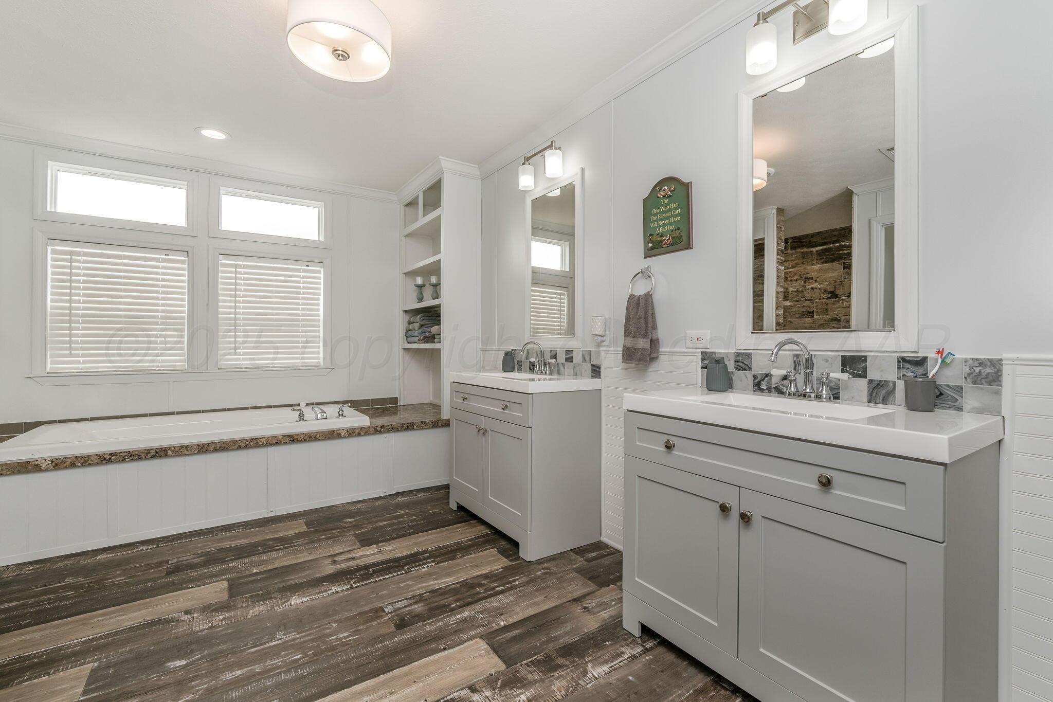 441 West Plantation Road Amarillo, TX 79118 - Photo 11 of 25 a bathroom with a granite countertop sink mirror and a bathtub