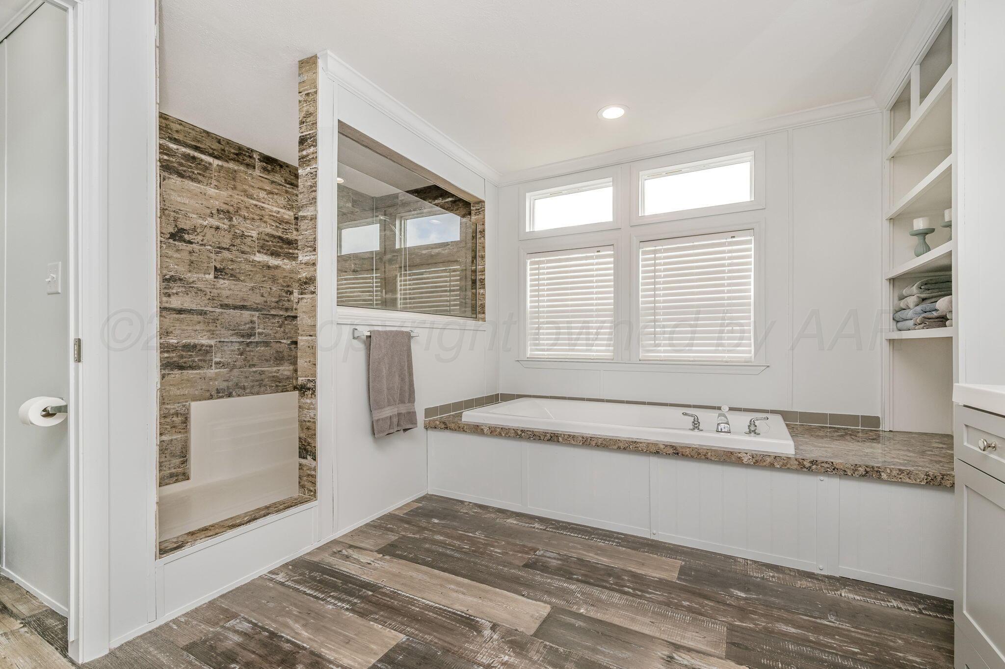 441 West Plantation Road Amarillo, TX 79118 - Photo 12 of 25 a spacious bathroom with a granite countertop tub and a sink