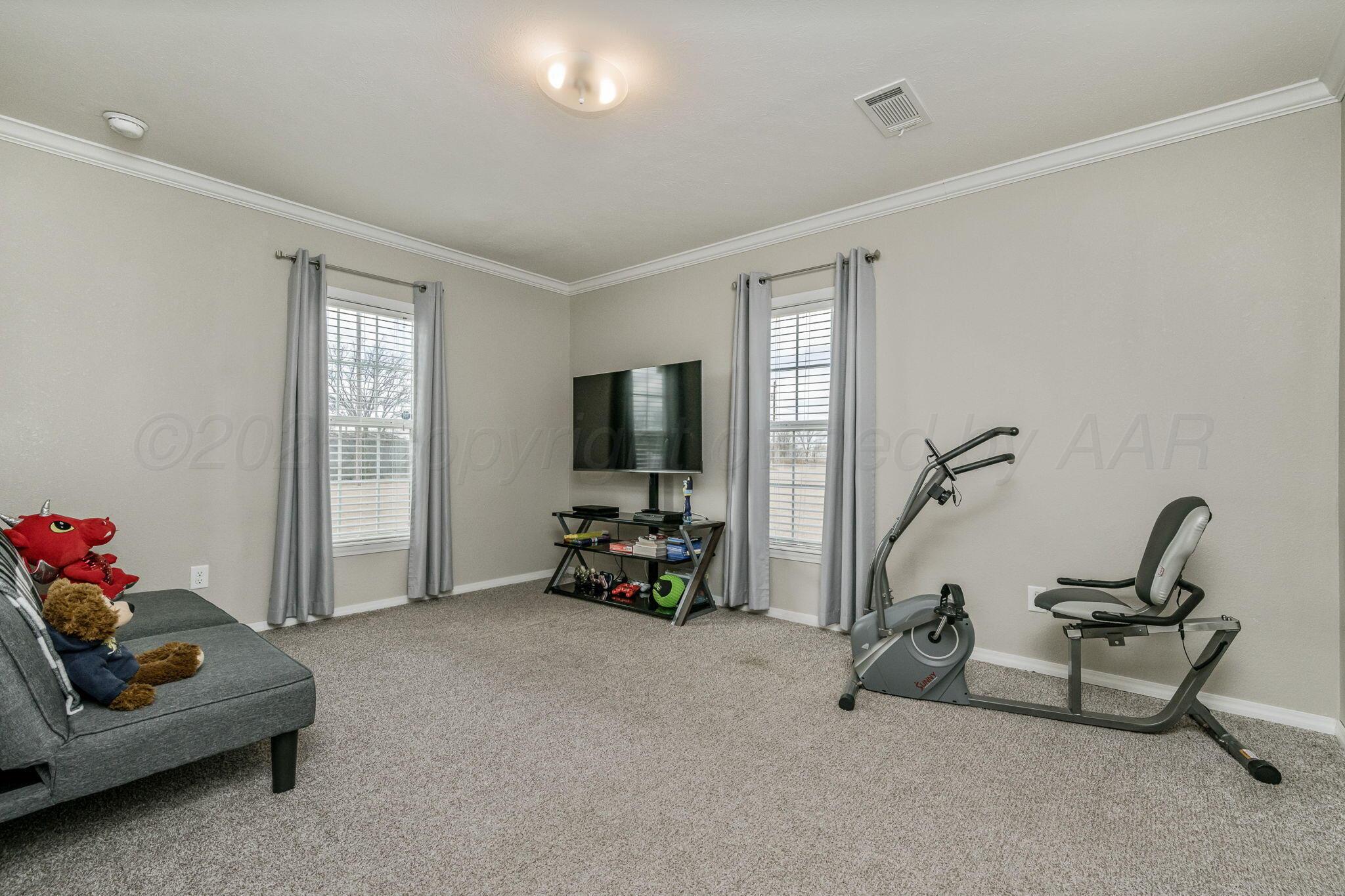 441 West Plantation Road Amarillo, TX 79118 - Photo 15 of 25 a living room with furniture a flat screen tv and a window