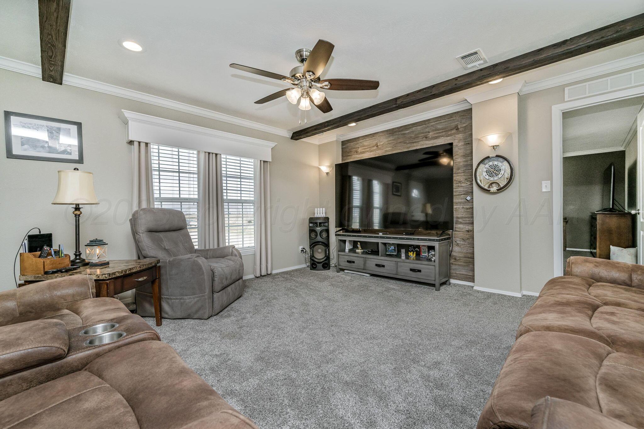441 West Plantation Road Amarillo, TX 79118 - Photo 3 of 25 a living room with furniture and a flat screen tv