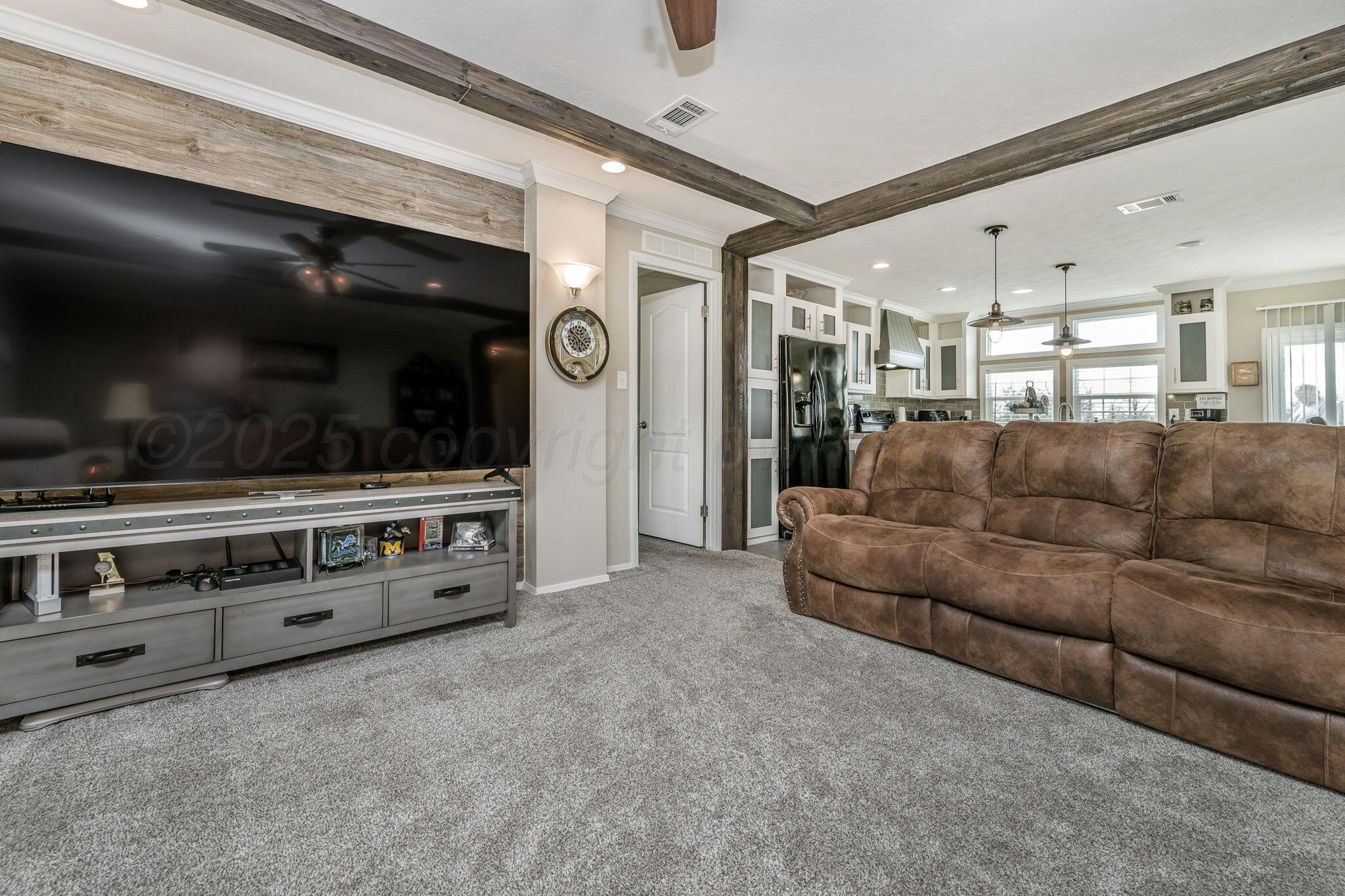 441 West Plantation Road Amarillo, TX 79118 - Photo 4 of 25 a living room with furniture and a flat screen tv