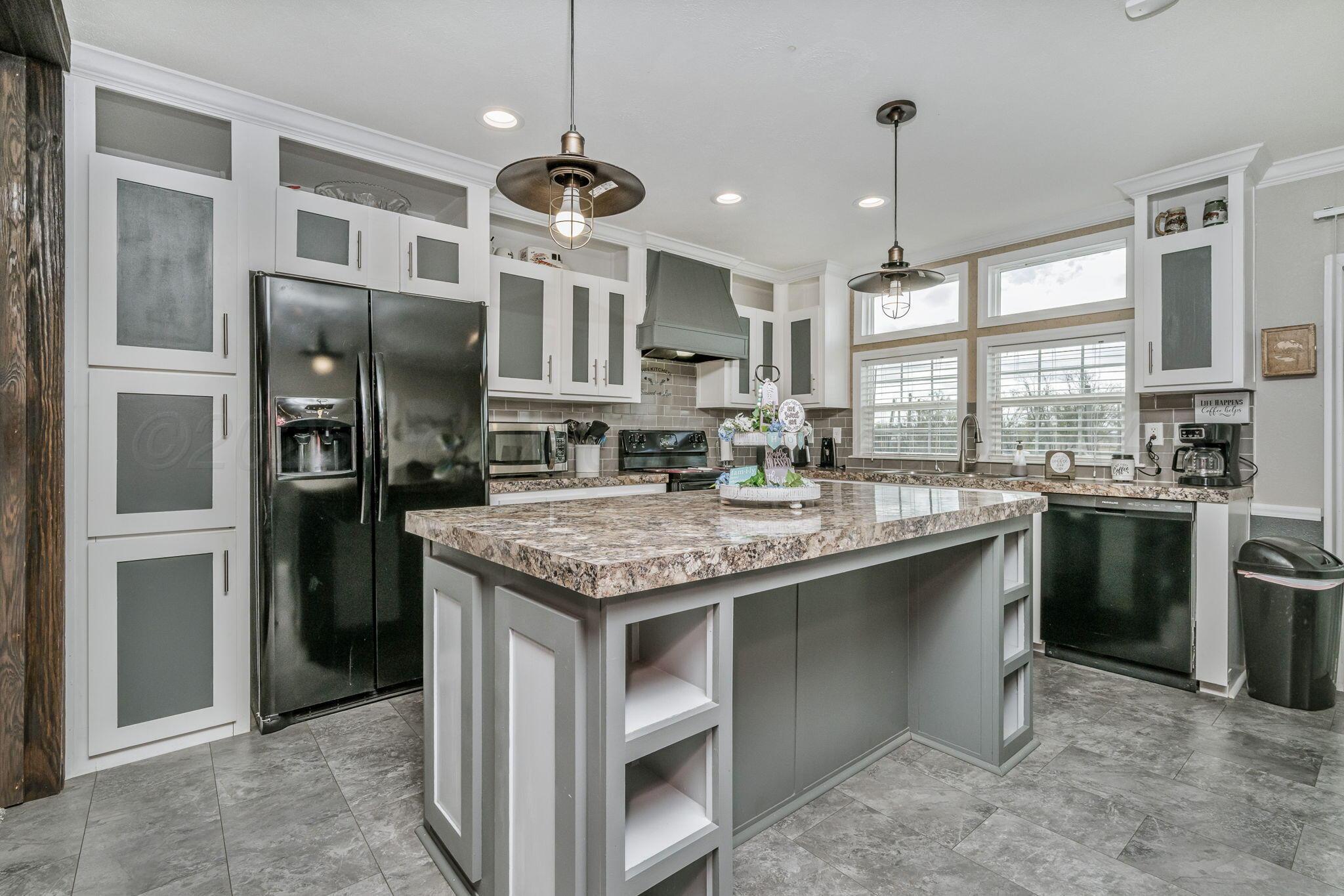 441 West Plantation Road Amarillo, TX 79118 - Photo 5 of 25 a kitchen with stainless steel appliances granite countertop a refrigerator a sink and a stove