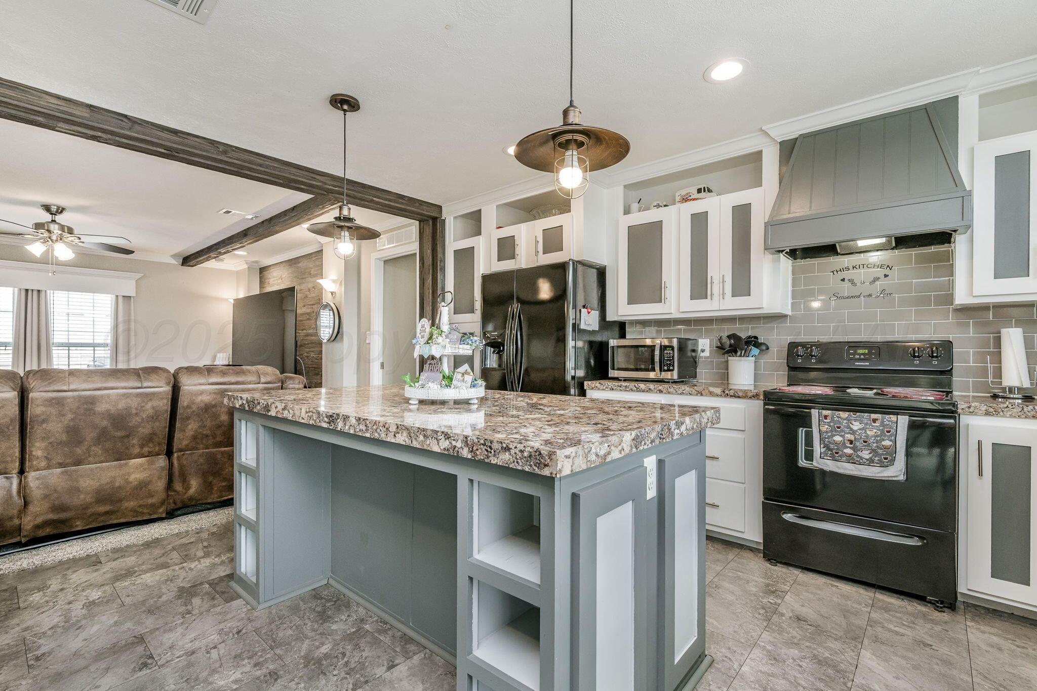 441 West Plantation Road Amarillo, TX 79118 - Photo 7 of 25 a kitchen with stainless steel appliances granite countertop a stove cabinets and refrigerator