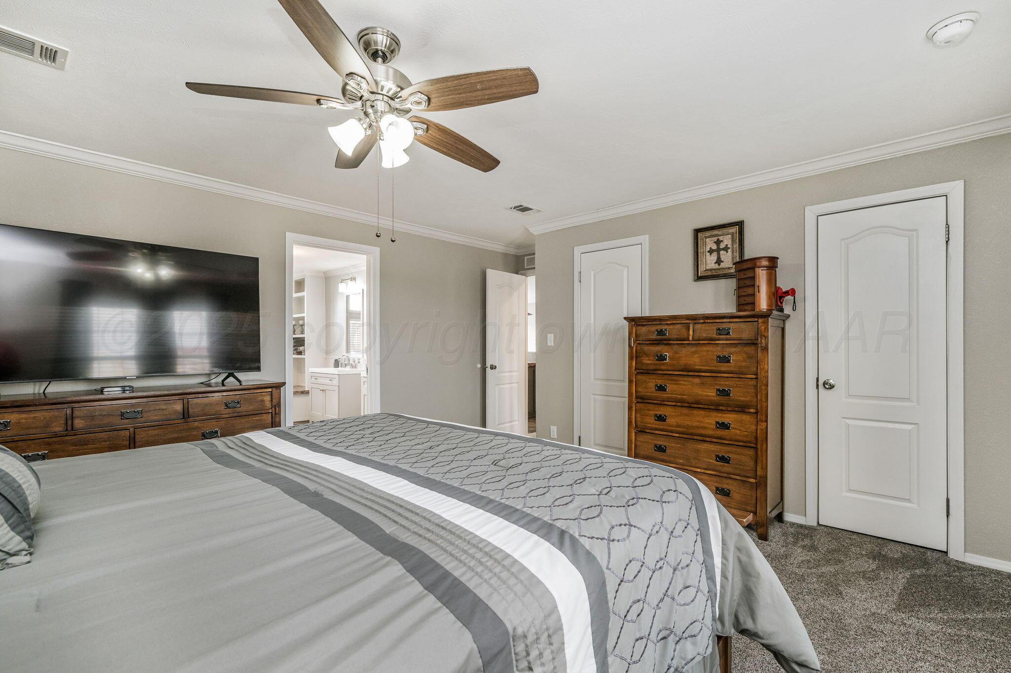 441 West Plantation Road Amarillo, TX 79118 - Photo 10 of 25 a bedroom with a bed and a flat screen tv