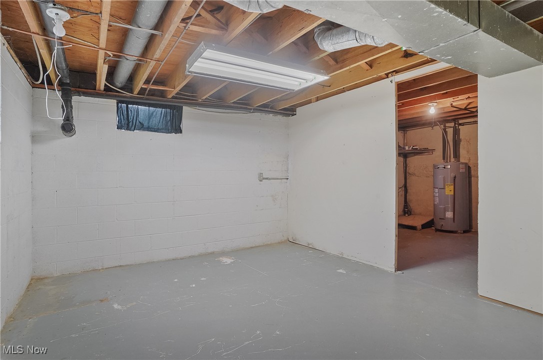 12395 Carter Road Painesville, OH 44077 - Photo 36 of 39 Unfinished below grade area featuring water heater