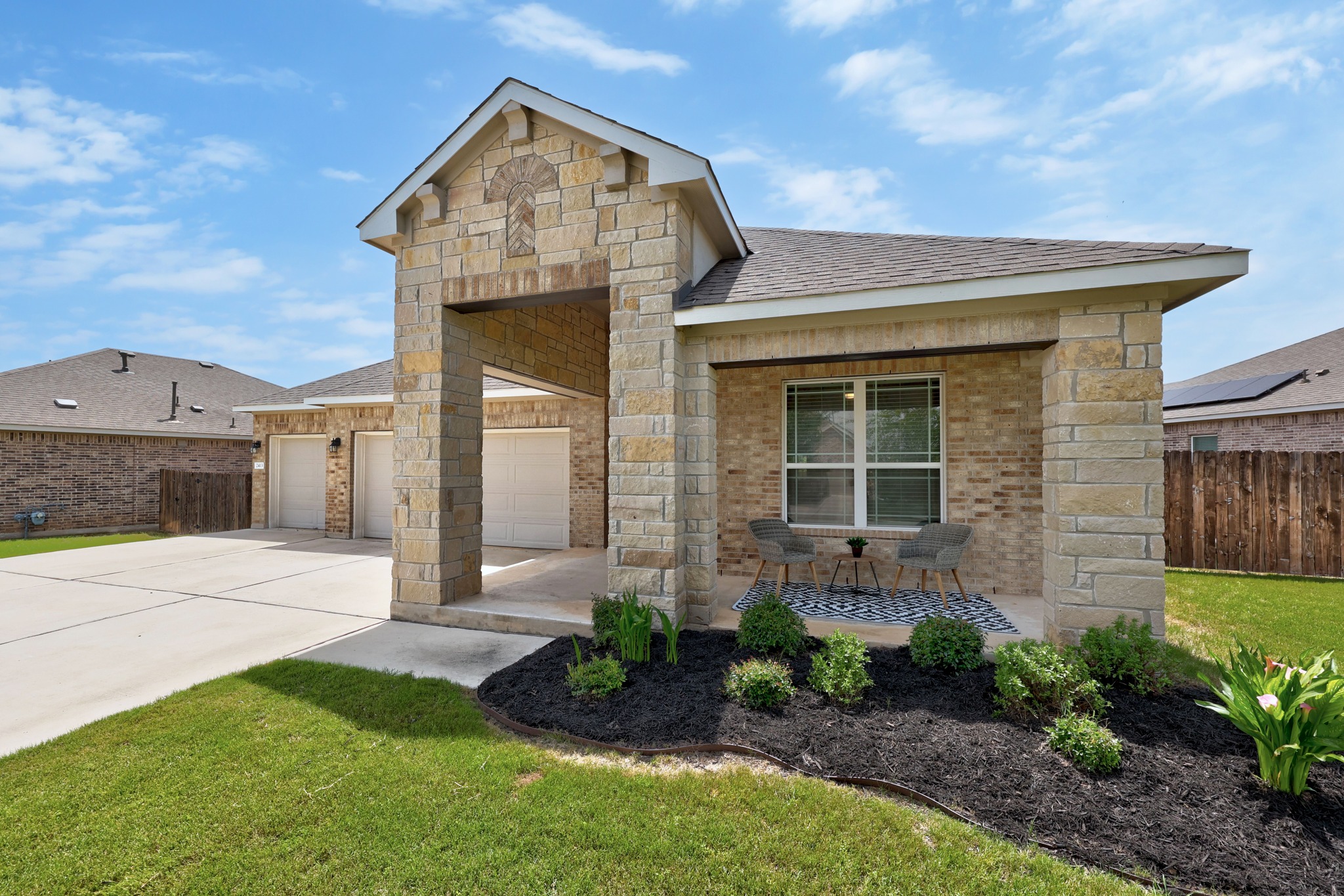 2413 Starhill Ranch Street Georgetown, TX 78628 - Photo 3 of 40 a front view of a house with garden