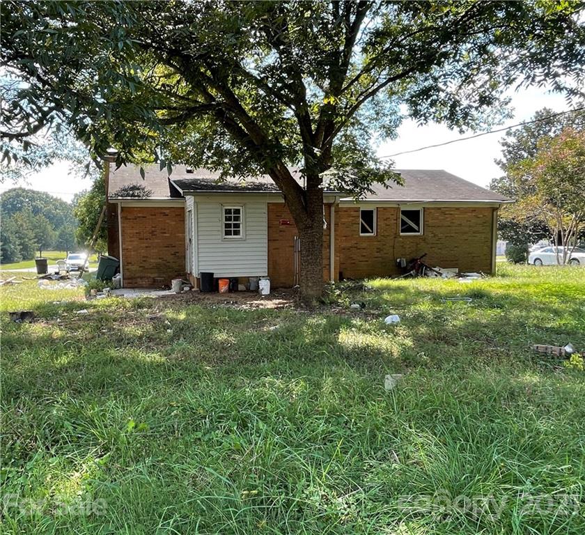 a front view of house with yard and trees
