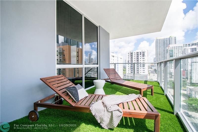 1010 Southwest 2nd Avenue, Unit 804 Miami, FL 33130 - Photo 1 of 12 a view of a patio with chair and chairs
