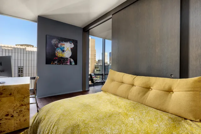 a bedroom with a bed and cupboard