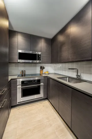 a kitchen with stainless steel appliances a stove sink and cabinets