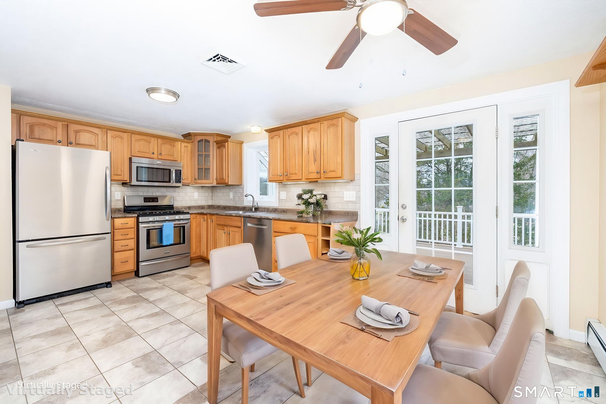 8 Still Field Road Manchester, CT 06040 - Photo 13 of 38 a kitchen with a refrigerator a stove a dining table and chairs