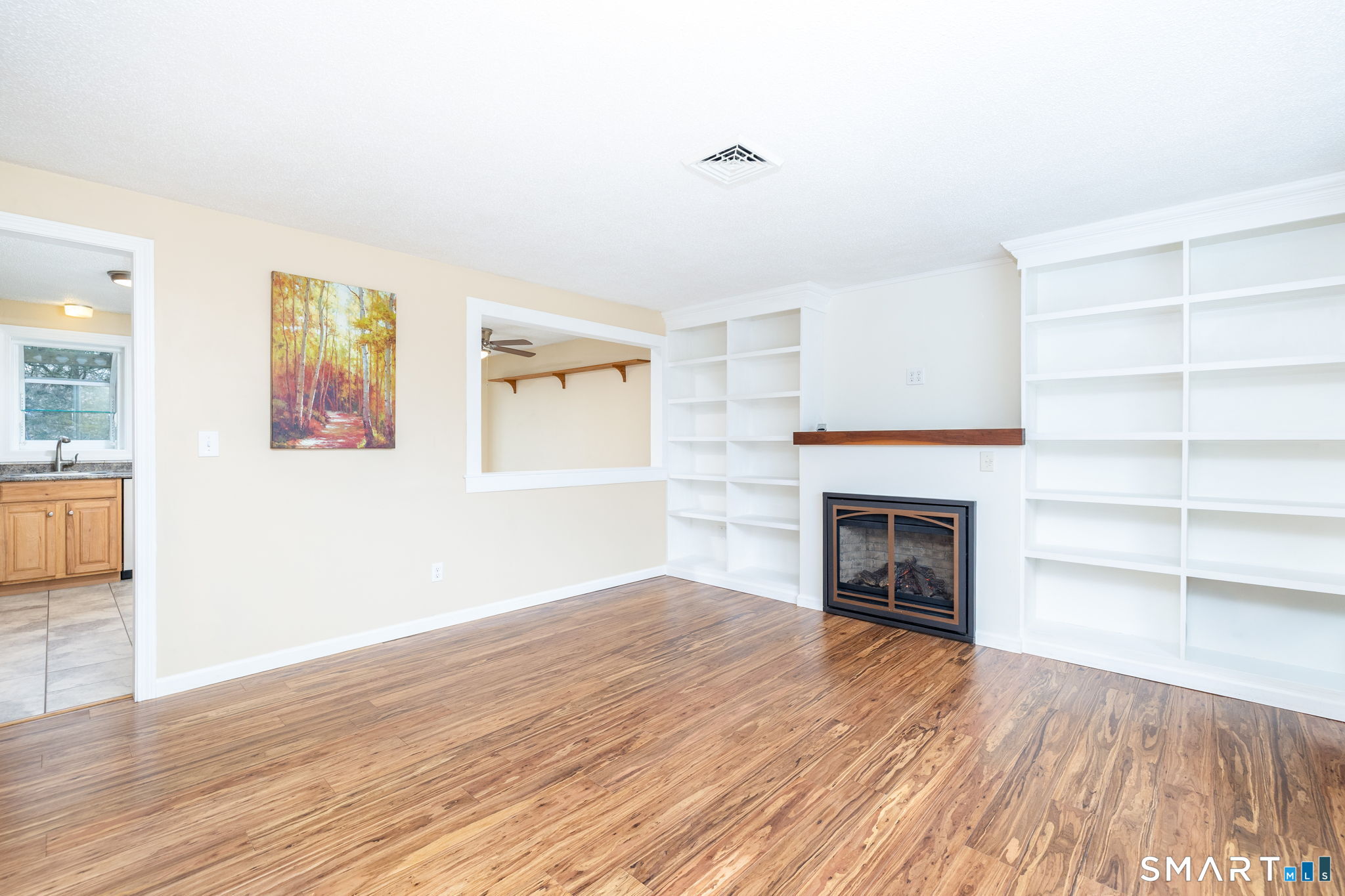 8 Still Field Road Manchester, CT 06040 - Photo 16 of 38 a view of a livingroom with wooden floor and a fireplace