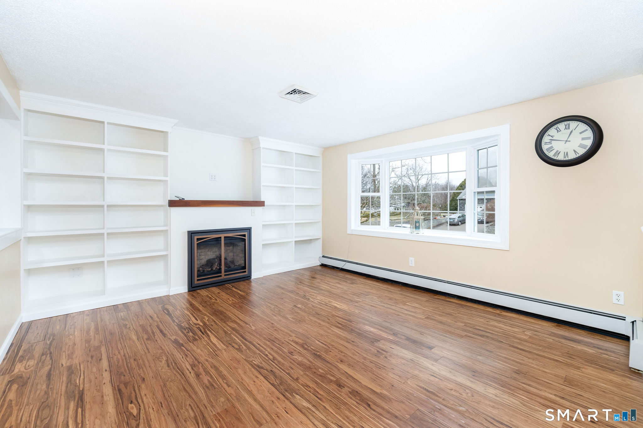 8 Still Field Road Manchester, CT 06040 - Photo 18 of 38 an empty room with a fireplace and wooden floor