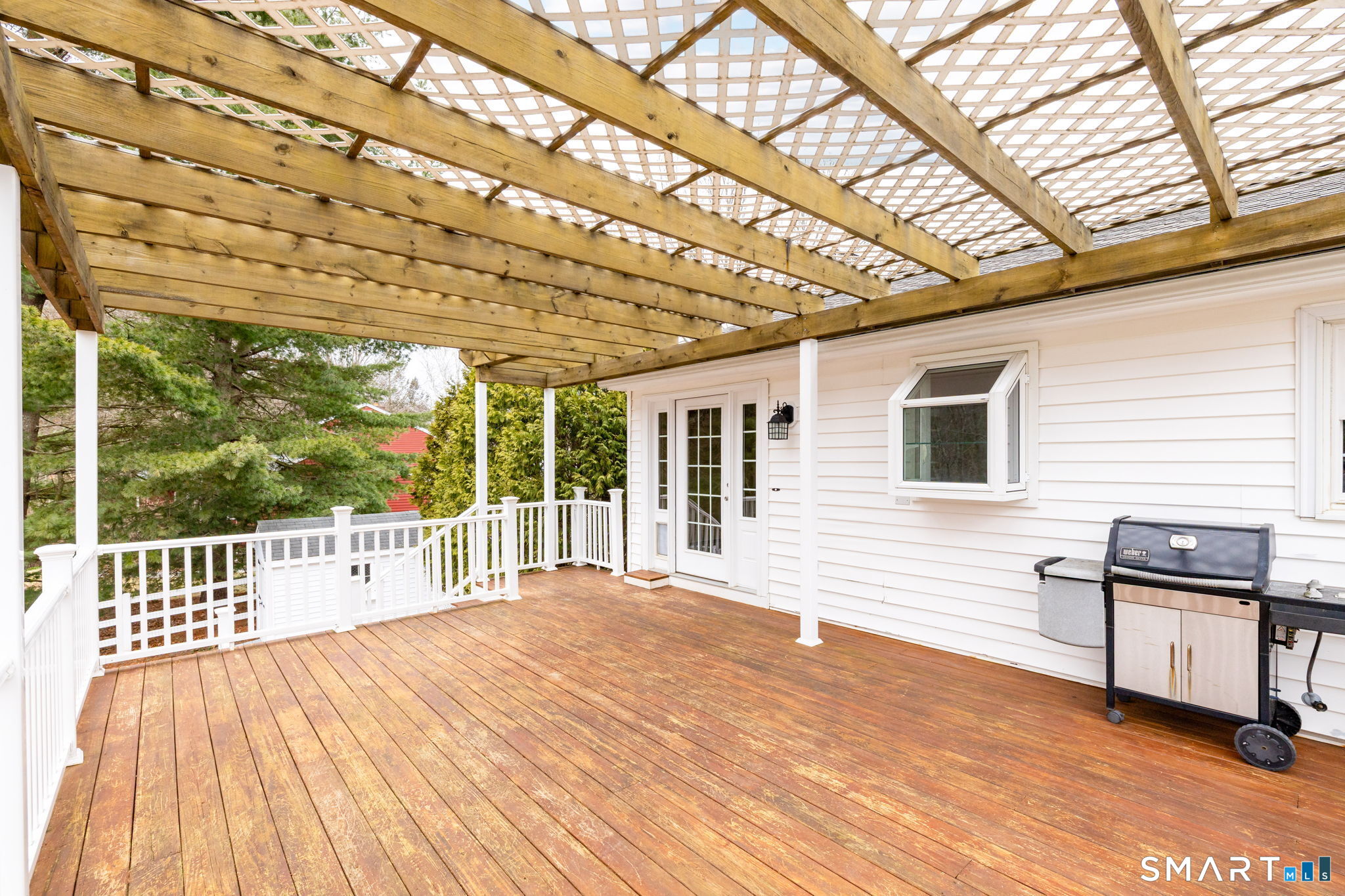 8 Still Field Road Manchester, CT 06040 - Photo 10 of 38 a view of a deck with wooden floor and roof with a garden view