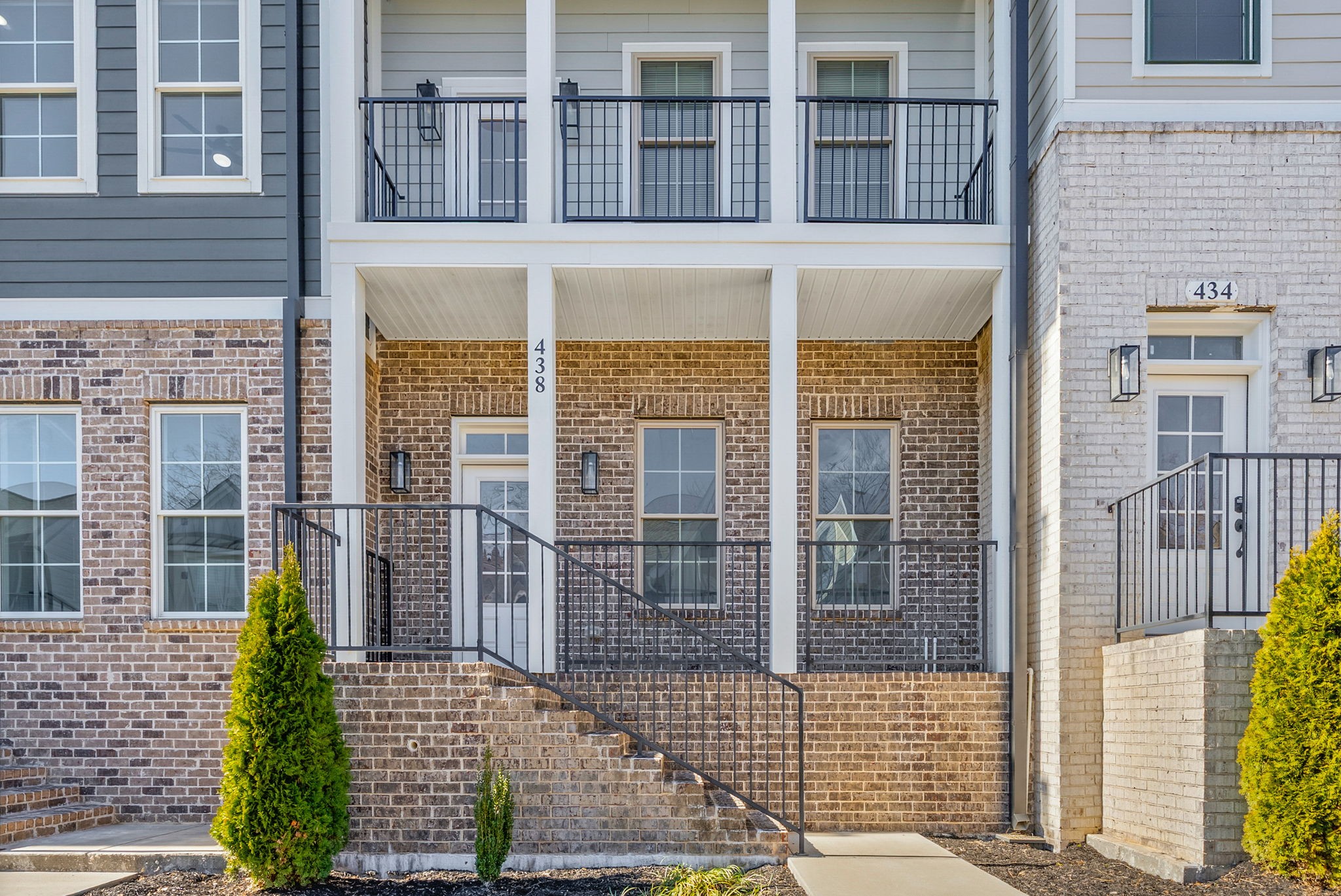 a view of a brick house with large windows
