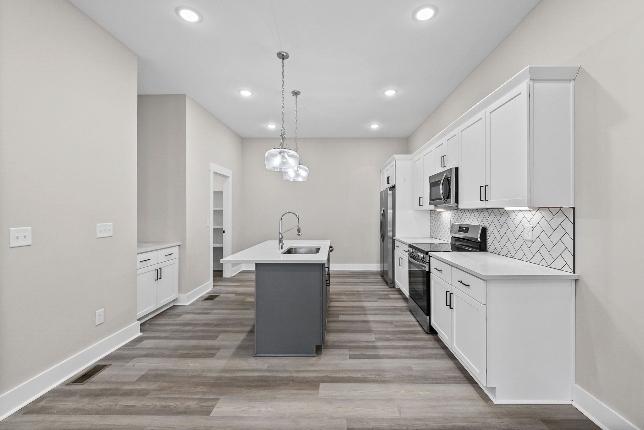 438 Centre Street Pleasant View, TN 37146 - Photo 19 of 44 a large kitchen with stainless steel appliances a large center island in the center