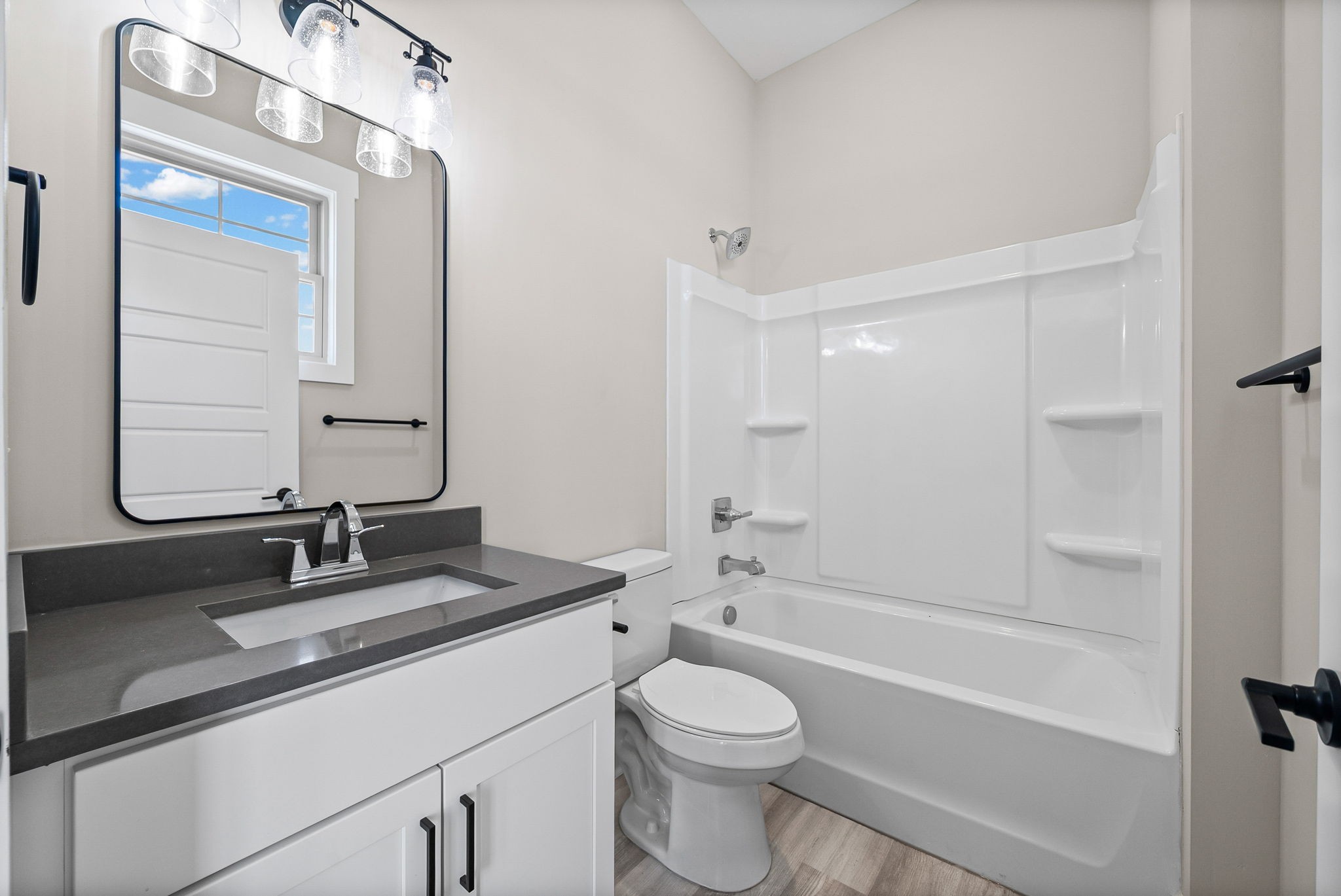 438 Centre Street Pleasant View, TN 37146 - Photo 30 of 44 a bathroom with a granite countertop sink toilet a mirror and shower