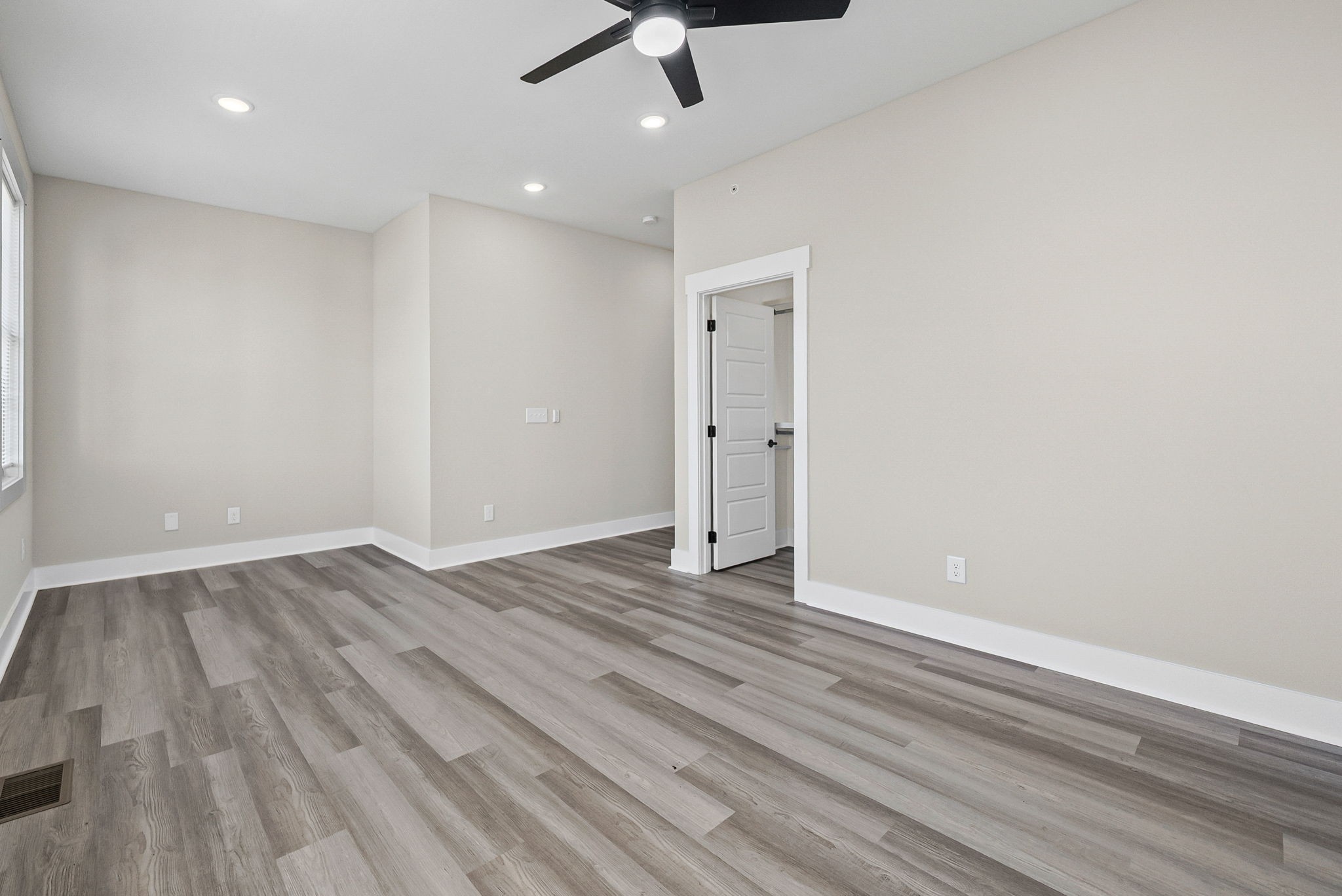 438 Centre Street Pleasant View, TN 37146 - Photo 32 of 44 an empty room with wooden floor ceiling fan and window