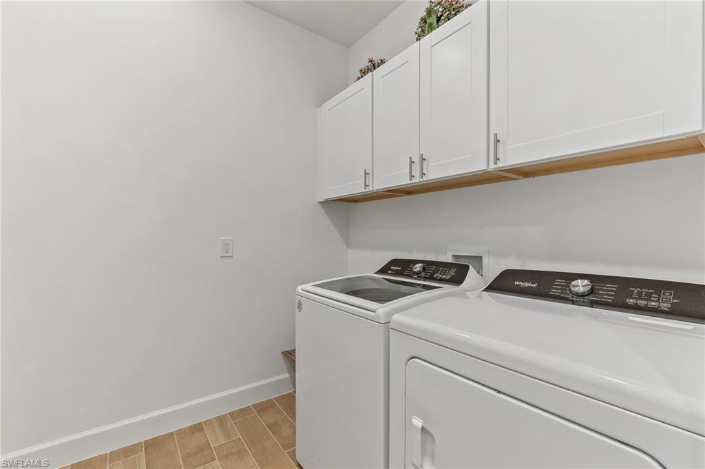15850 Blue Rdg Way Punta Gorda, FL 33982 - Photo 18 of 23 a utility room with dryer and cabinets