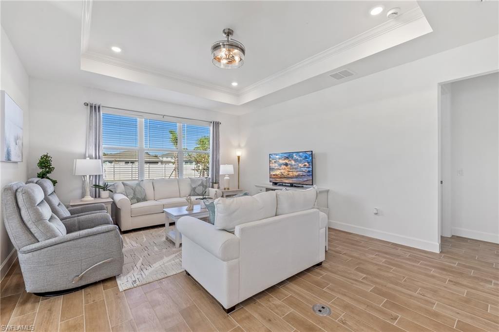 15850 Blue Rdg Way Punta Gorda, FL 33982 - Photo 3 of 23 a living room with furniture and a wooden floor