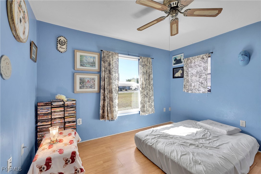 19165 Coconut Road Fort Myers, FL 33967 - Photo 12 of 27 a bedroom with a bed and a chandelier