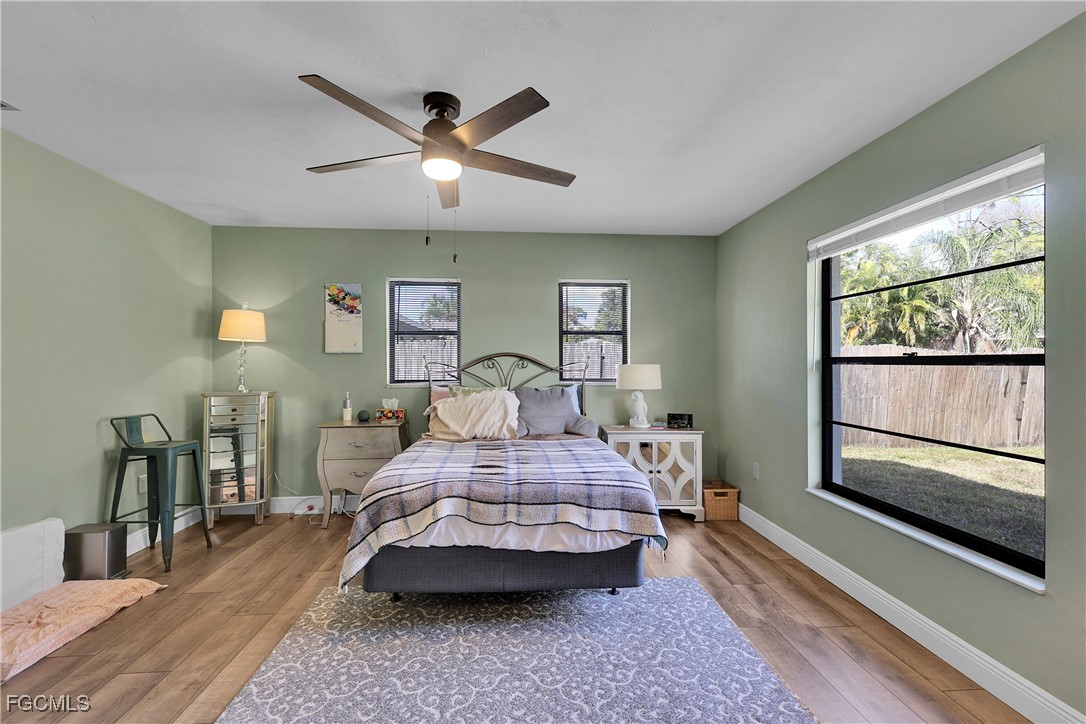 19165 Coconut Road Fort Myers, FL 33967 - Photo 14 of 27 a bedroom with a large bed and a large window