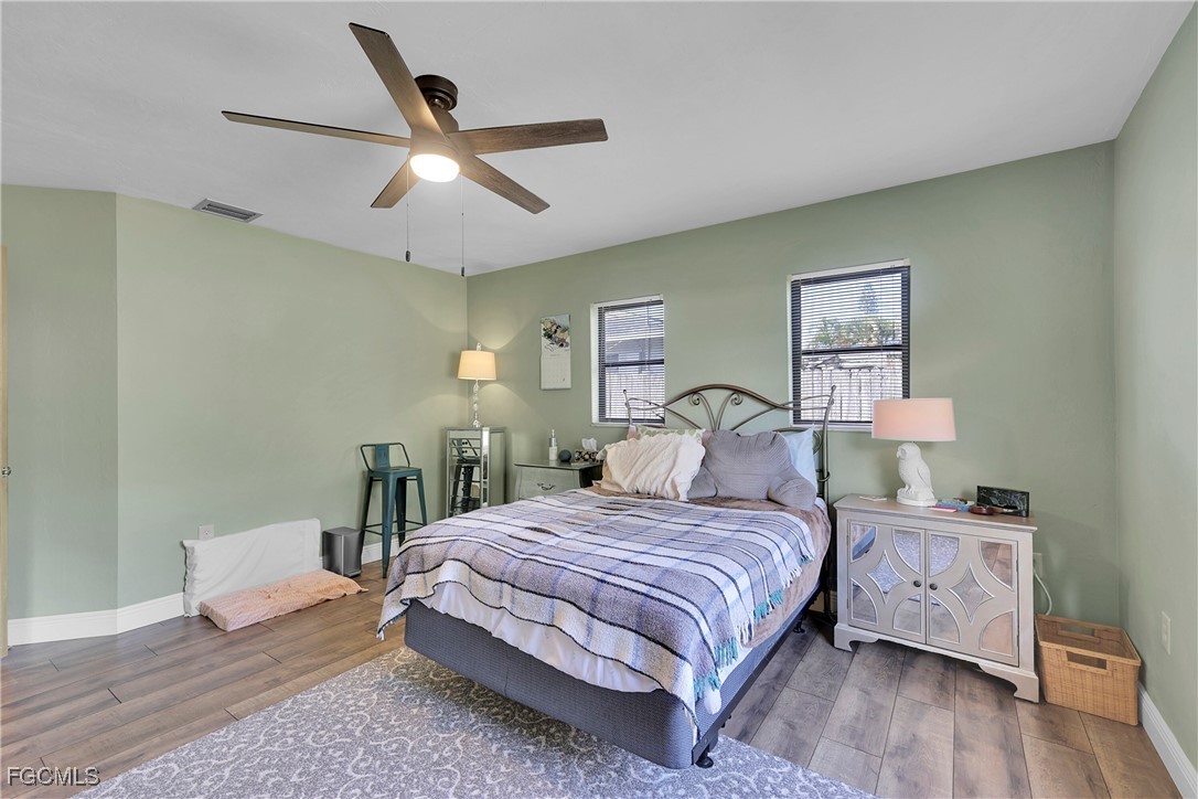 19165 Coconut Road Fort Myers, FL 33967 - Photo 15 of 27 a bedroom with a large bed and a chandelier