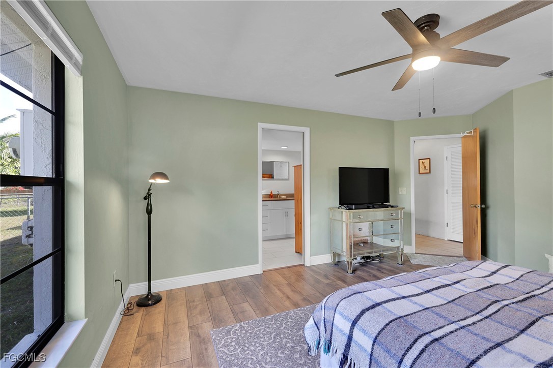 19165 Coconut Road Fort Myers, FL 33967 - Photo 16 of 27 a bedroom with a bed and a flat screen tv