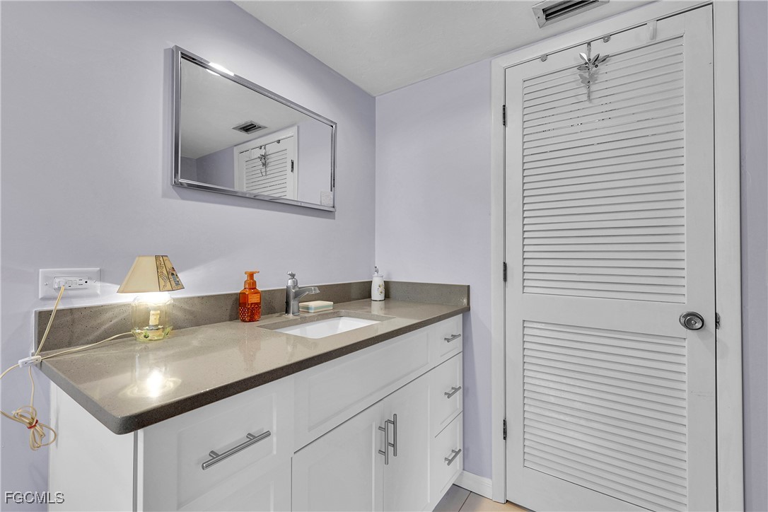 19165 Coconut Road Fort Myers, FL 33967 - Photo 17 of 27 a bathroom with a sink and a mirror