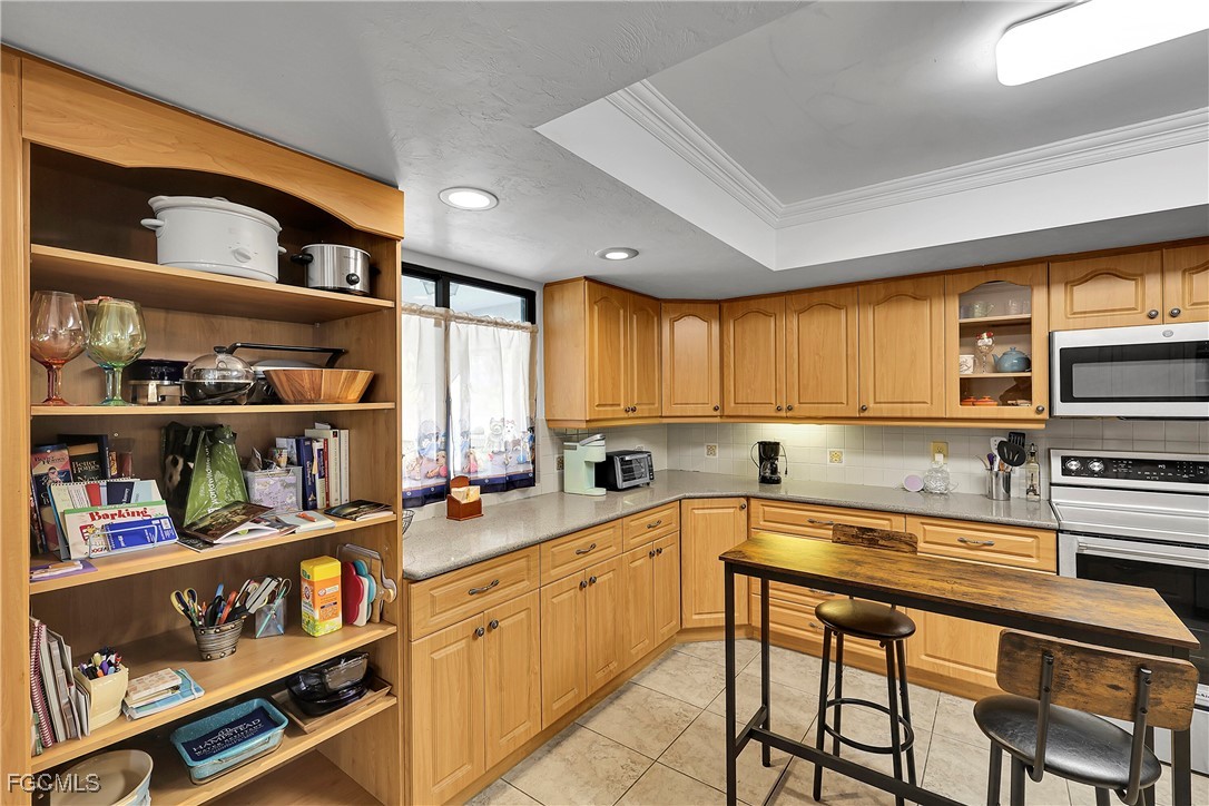 19165 Coconut Road Fort Myers, FL 33967 - Photo 6 of 27 a kitchen with stainless steel appliances a stove a sink and cabinets