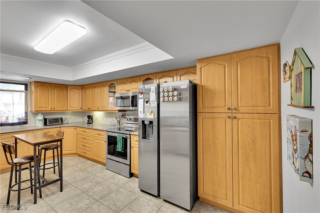 19165 Coconut Road Fort Myers, FL 33967 - Photo 9 of 27 a kitchen with a refrigerator and countertop
