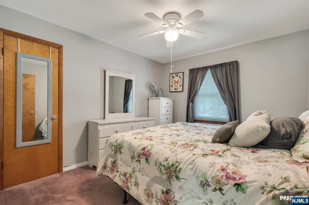 55 Marcia Road Ringwood, NJ 07456 - Photo 17 of 42 a bedroom with a bed and a chandelier