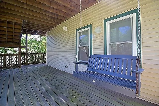 a view of a house with wooden deck