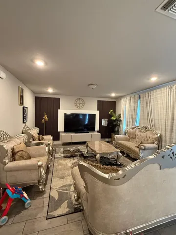 a living room with furniture and a flat screen tv