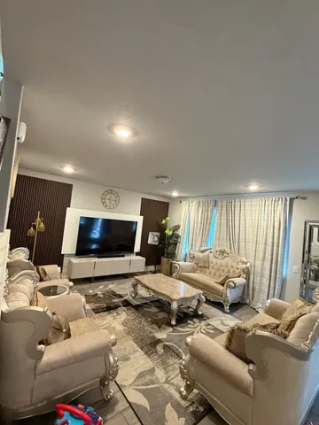 a living room with furniture and a flat screen tv