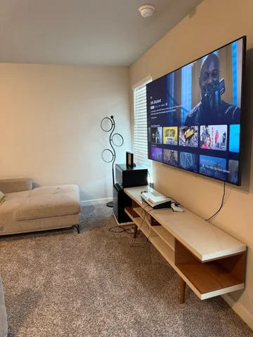 a bed sitting in a spacious bedroom next to a window