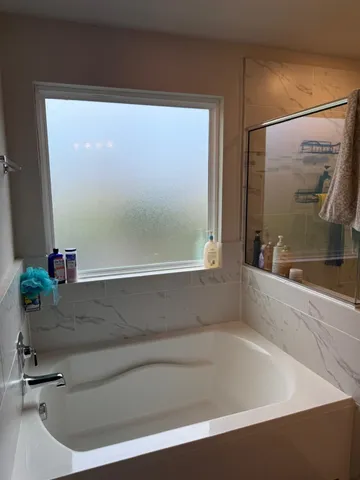 a bedroom with a bed and a lamp with the wooden floor