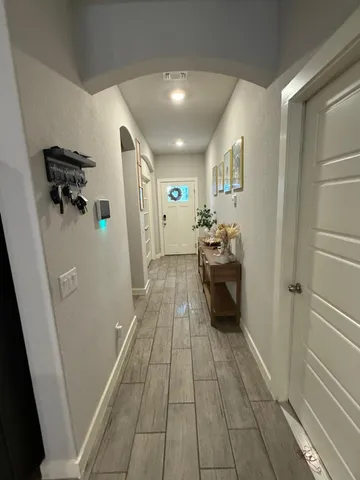 a living room with furniture and a wooden floor