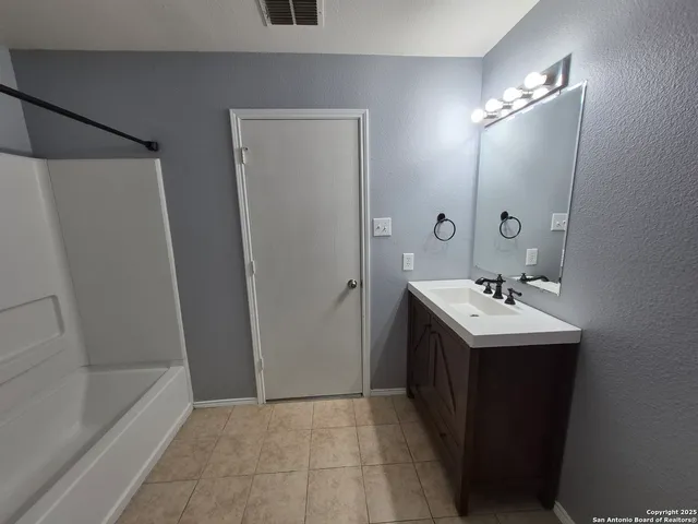 a bathroom with a sink a mirror and a bathtub