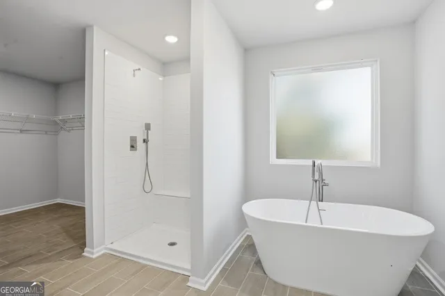a white bath tub sitting next to a shower