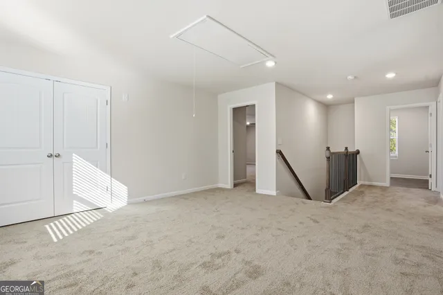 a view of a hallway with wooden floor and windows