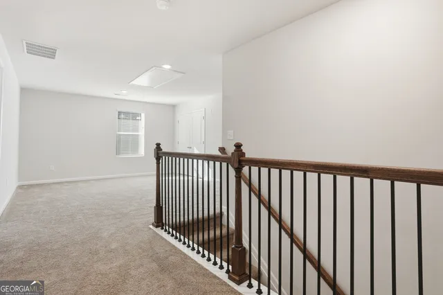 an empty room with windows and ceiling fan