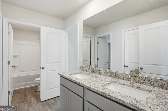 a white toilet sitting next to a bath tub