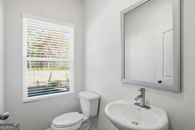 a view of a room with wooden floor and a window