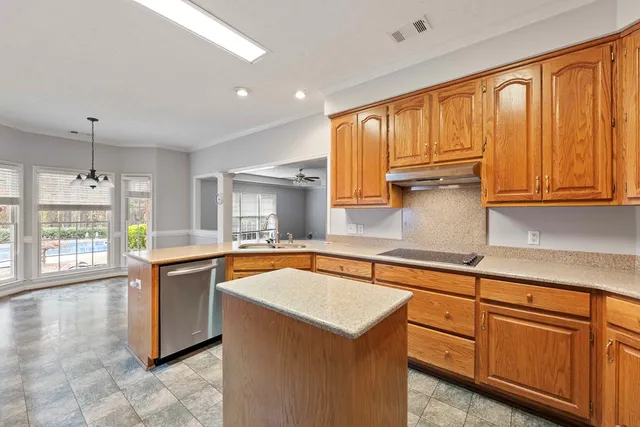 a kitchen with stainless steel appliances granite countertop a sink stove and cabinets
