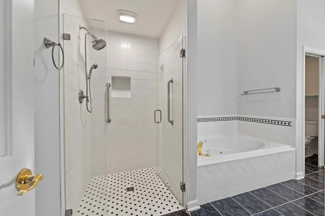 a bathroom with a bathtub a shower and a shower