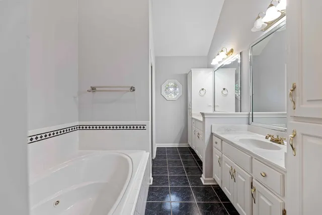 a bathroom with a double vanity sink and a bathtub