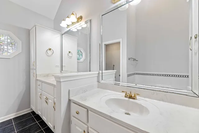 a bathroom with a sink a vanity and a mirror