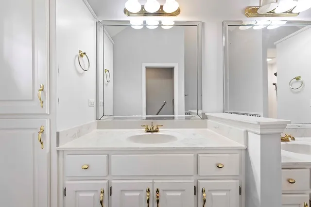 a bathroom with a sink vanity and a mirror
